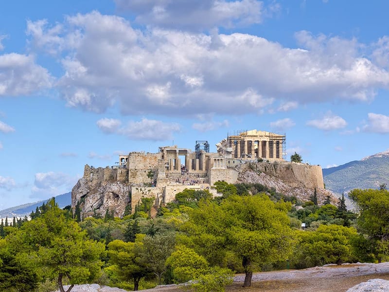 The Acropolis of Athens seen from the west, with the Parthenon on top and trees below