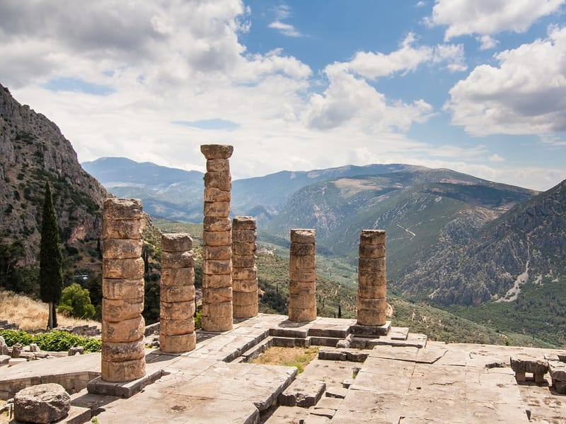 The columns of the Temple of Apollo at Delphi with the valley and mountains behind