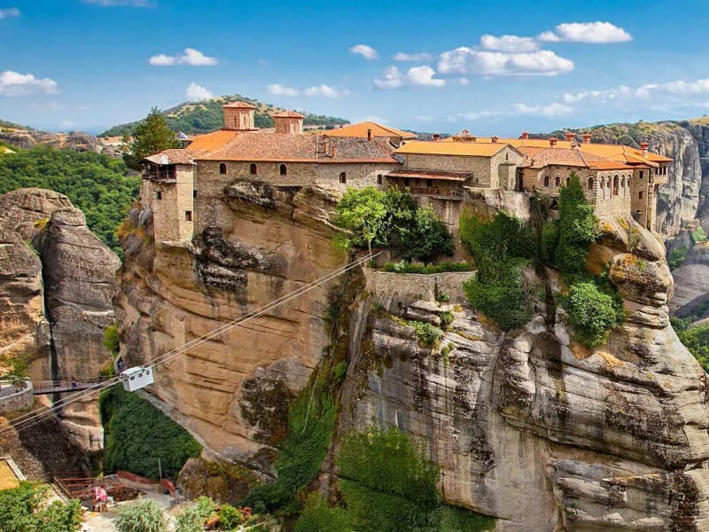 A monastery on a rock pillar at Meteora, with the valley behind