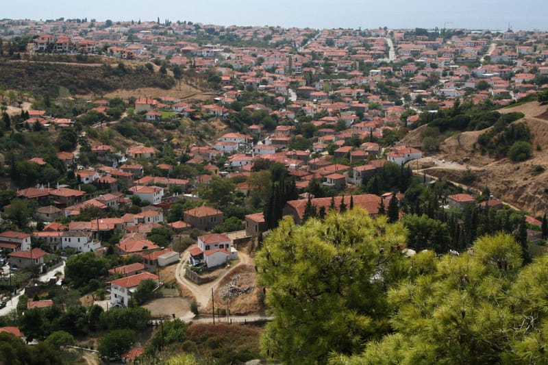 Old Nikiti on its hill with the cemetery church in the foreground, the modern village and the Toroneos gulf behind
