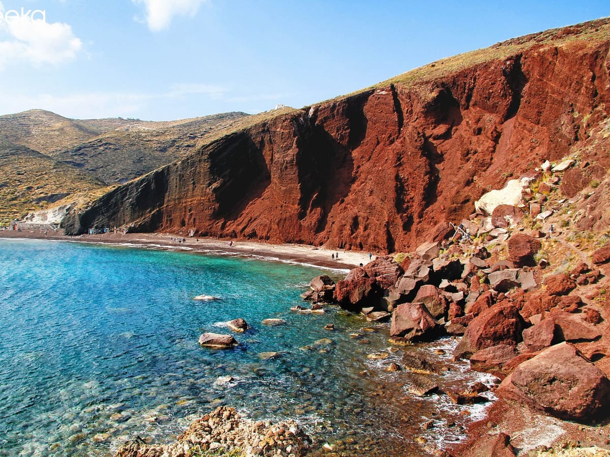 The red cliff of Red Beach and the sea below, seen from the path above the beach