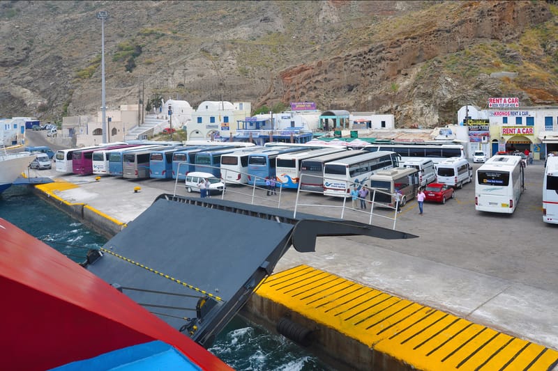 The quay of Athinios port, Santorini: coaches and cars waiting beside a ferry's ramp