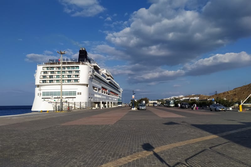 The cruise quay of the new port of Mykonos at Tourlos: a ship alongside, coaches and cars on the quay